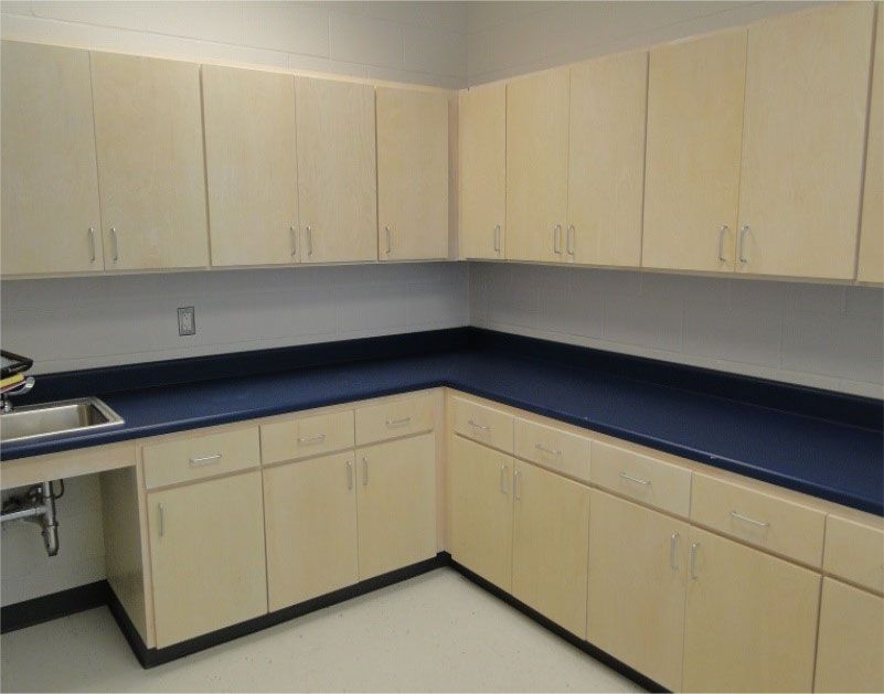 A kitchen with white cabinets and blue counter tops