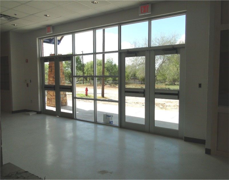 An empty room with a red exit sign on the wall