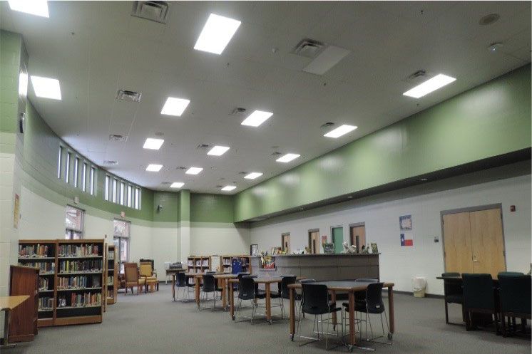 A library with tables and chairs and bookshelves