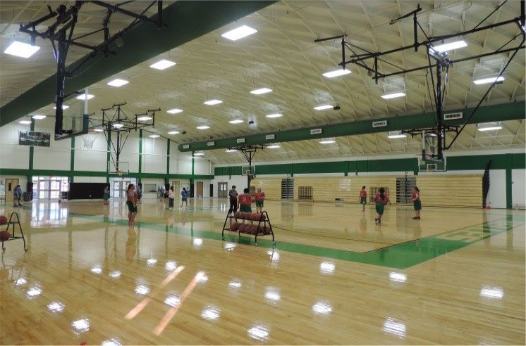 A group of people are playing basketball in a gym