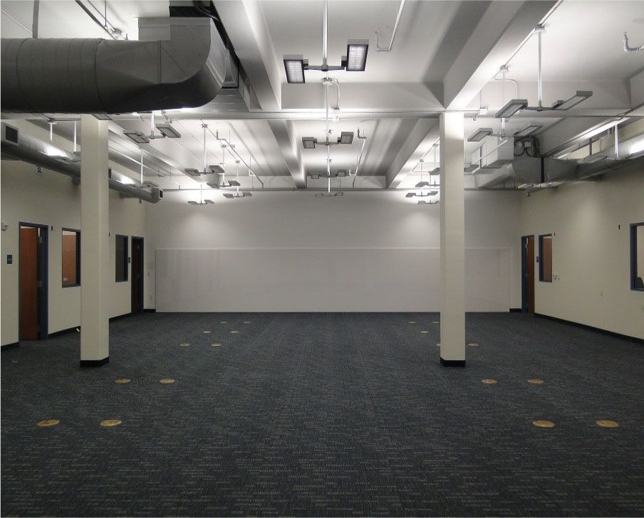 A large empty room with a carpeted floor