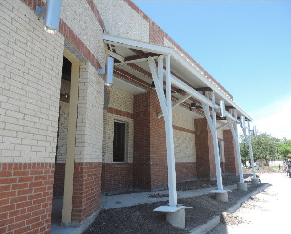 A brick building with a white awning over it