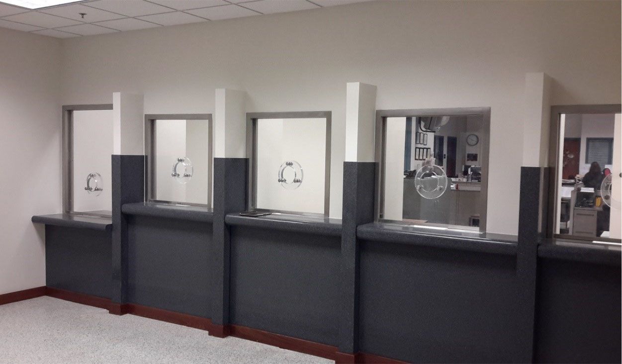 A room with a row of counters and a few windows