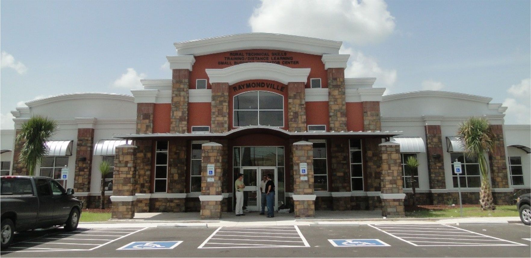 A large building with a handicapped parking spot in front of it