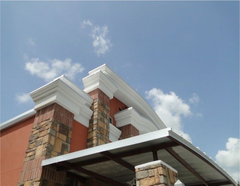 Looking up at the roof of a building with a blue sky in the background