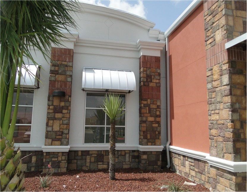 A building with a palm tree in front of it
