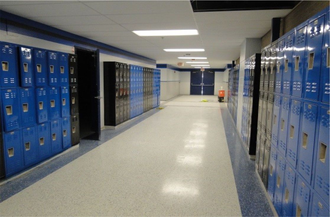 A long hallway filled with blue lockers in a school