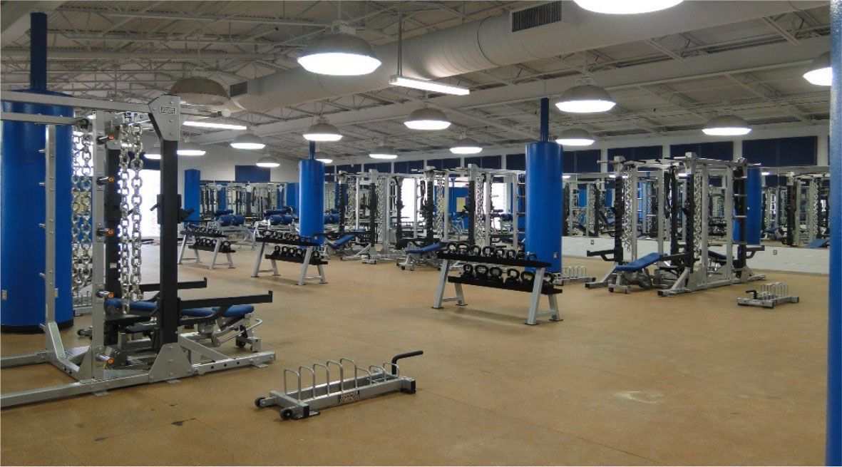 A large gym filled with lots of exercise equipment