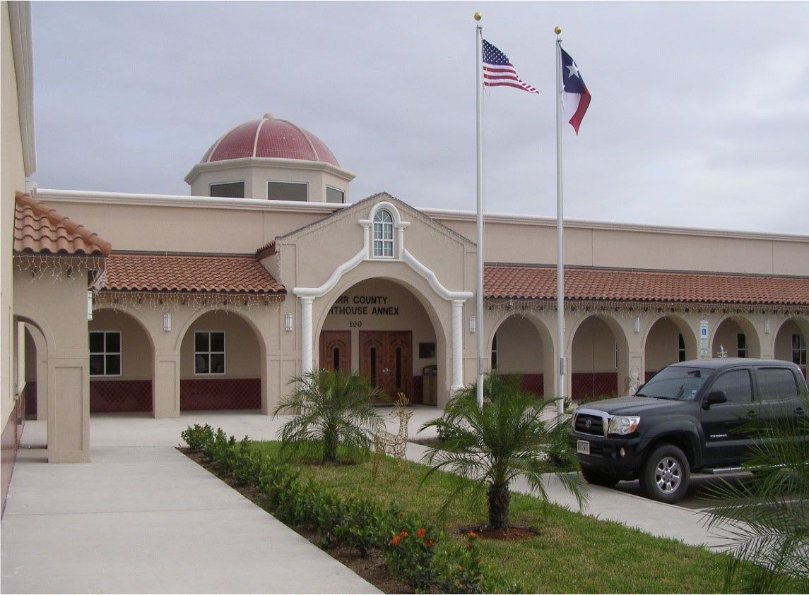 A black truck is parked in front of a building