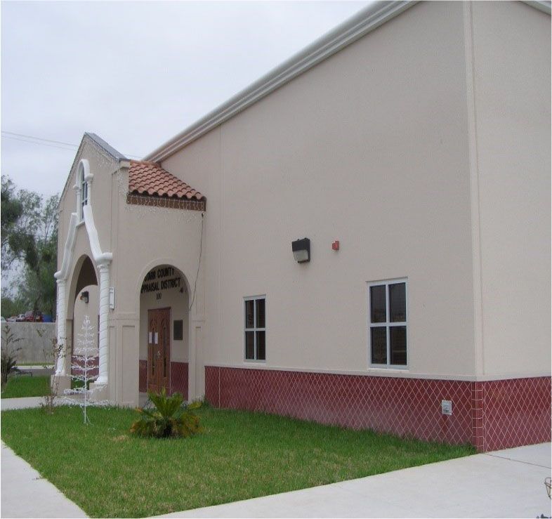 A white building with a red brick foundation