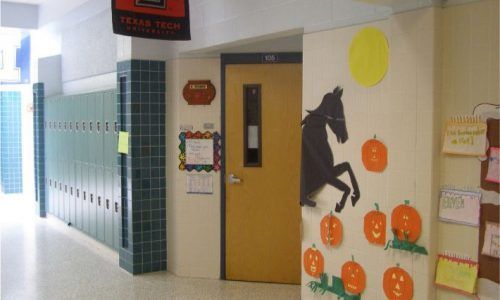 A hallway with a horse and pumpkins on the wall