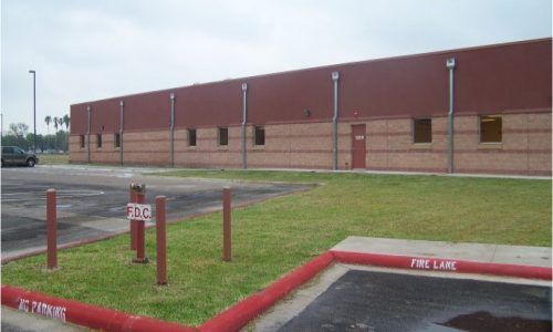 A brick building with a fire lane in front of it
