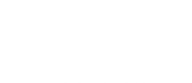 A white logo for a restaurant called truffles.