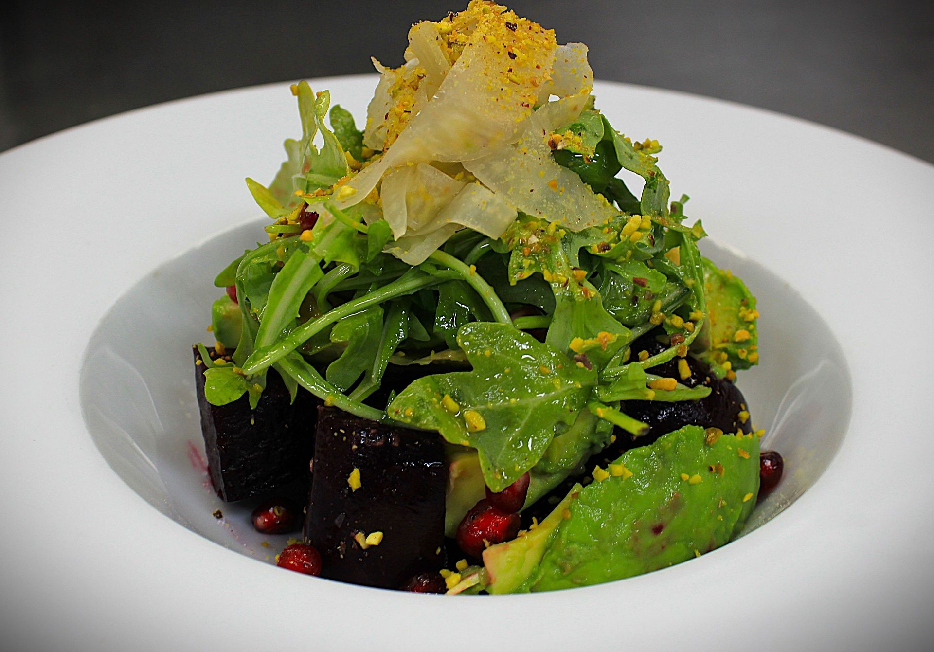 A close up of a salad in a white bowl