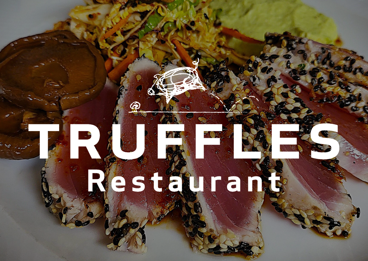 A white logo for a restaurant called truffles.