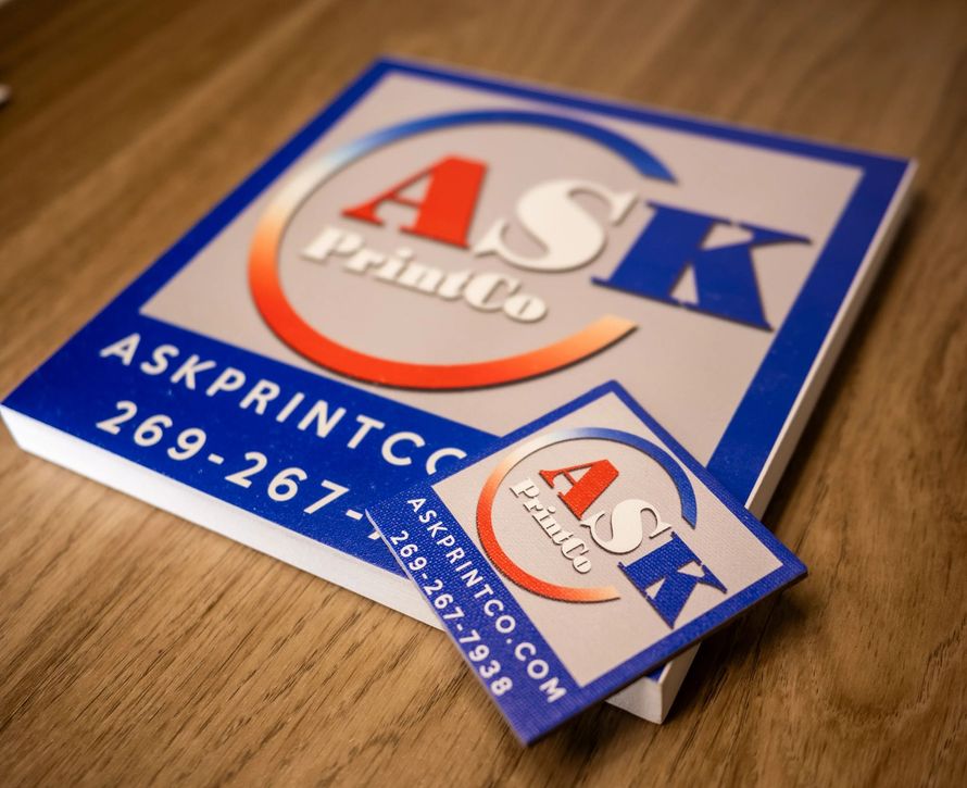 A book and a business card for ask print co.