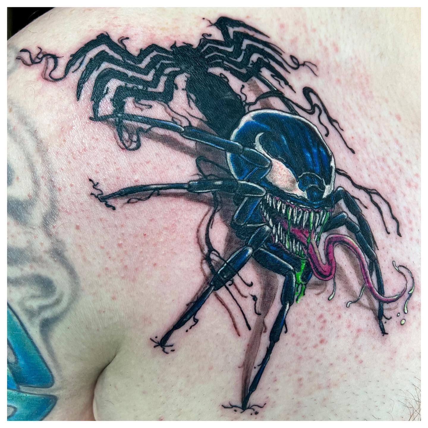 A man has a venom tattoo on his back