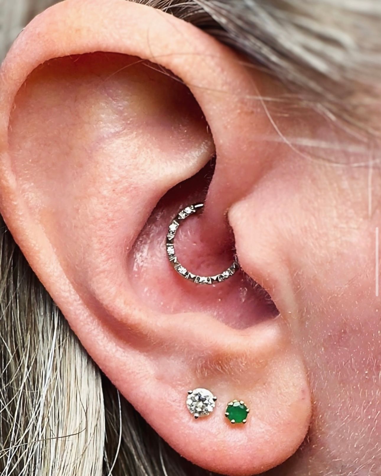 A close up of a woman 's ear with earrings