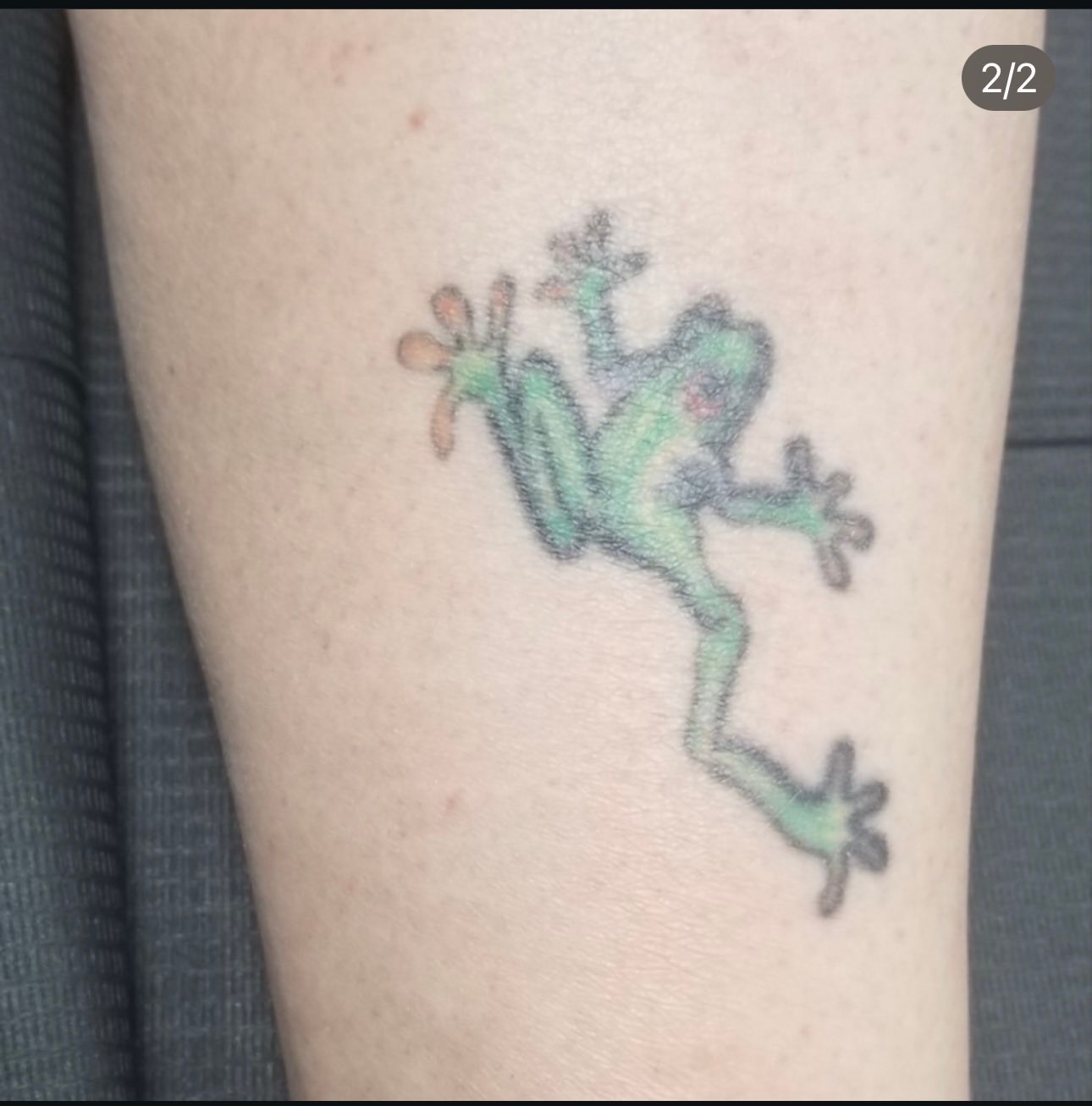 A person has a tattoo of a frog on their leg