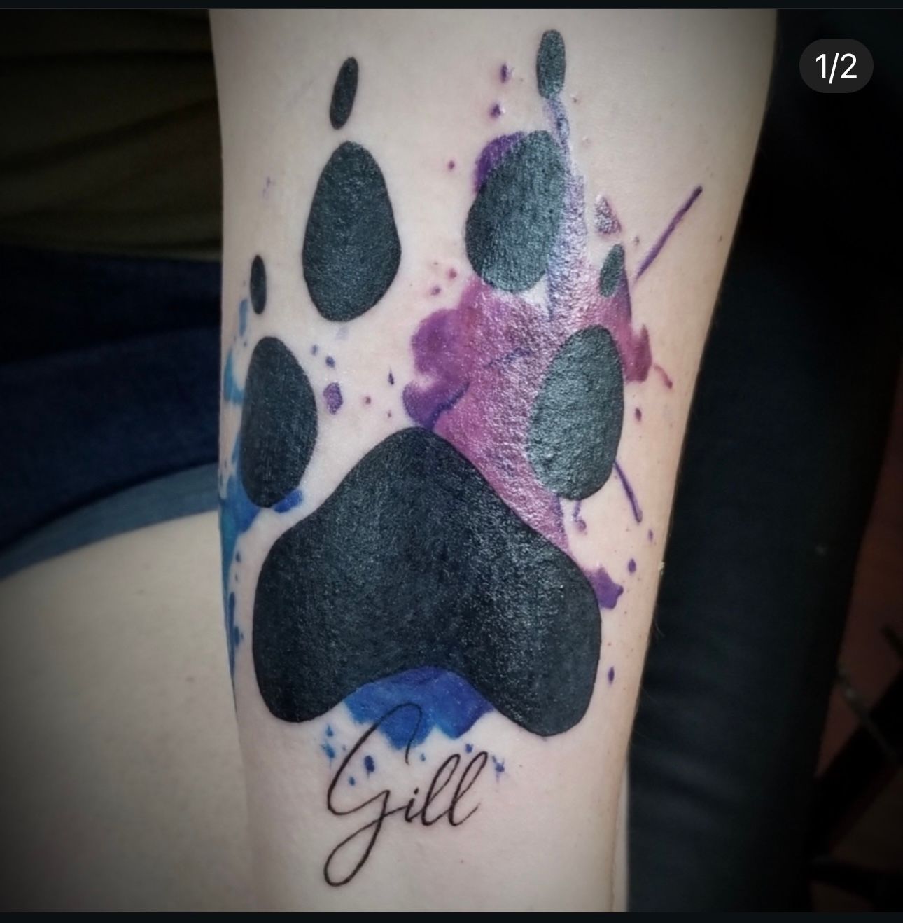 A tattoo of a paw print and the name gill