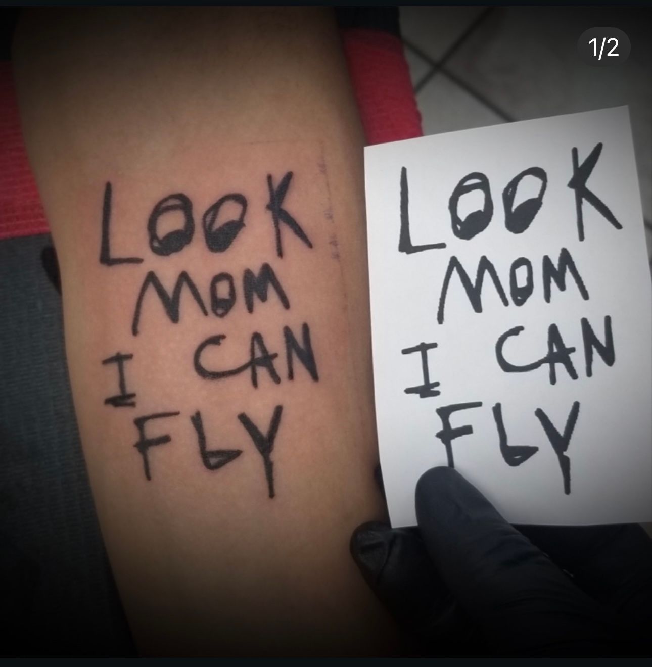 A person has a tattoo that says look mom i can fly