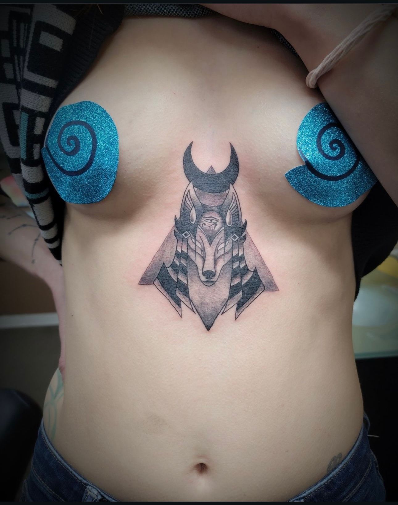 A woman has a tattoo of a wolf on her chest