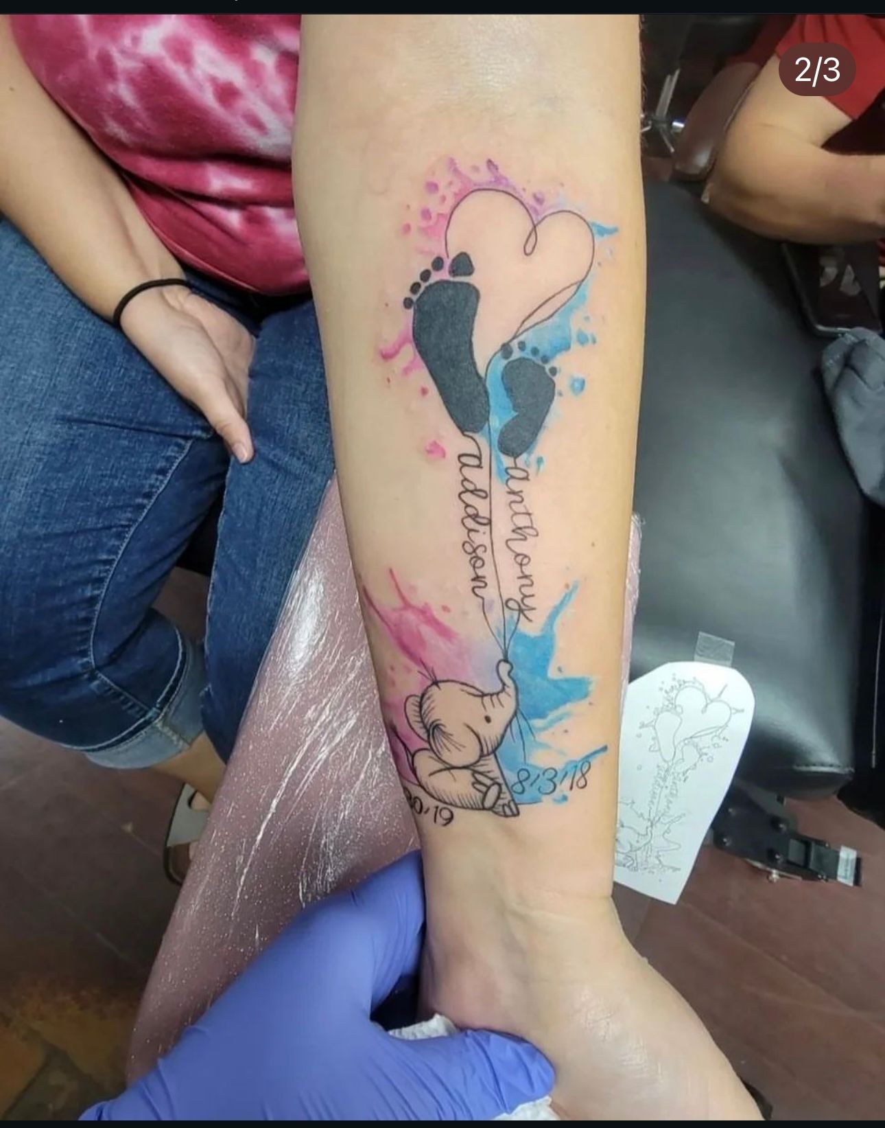 A woman has a tattoo of a baby 's footprints on her forearm