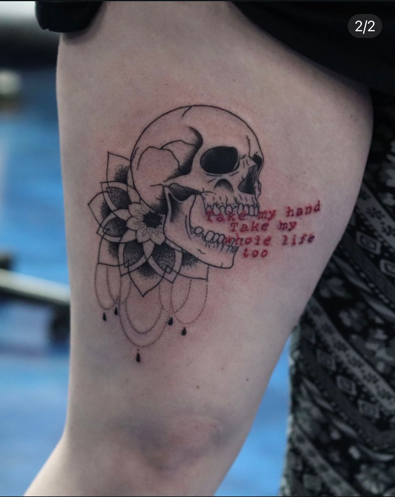 A person has a tattoo of a skull on their arm