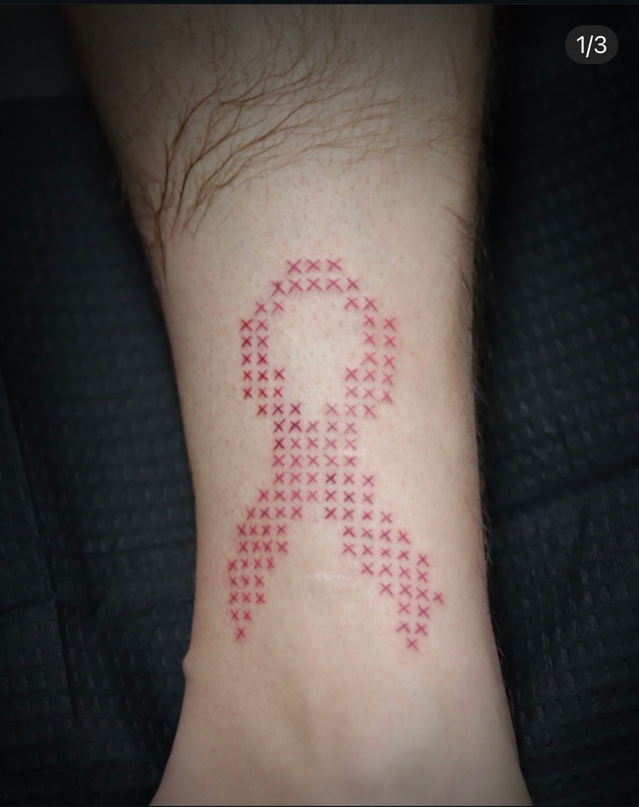 A person has a tattoo of a candy cane on their leg