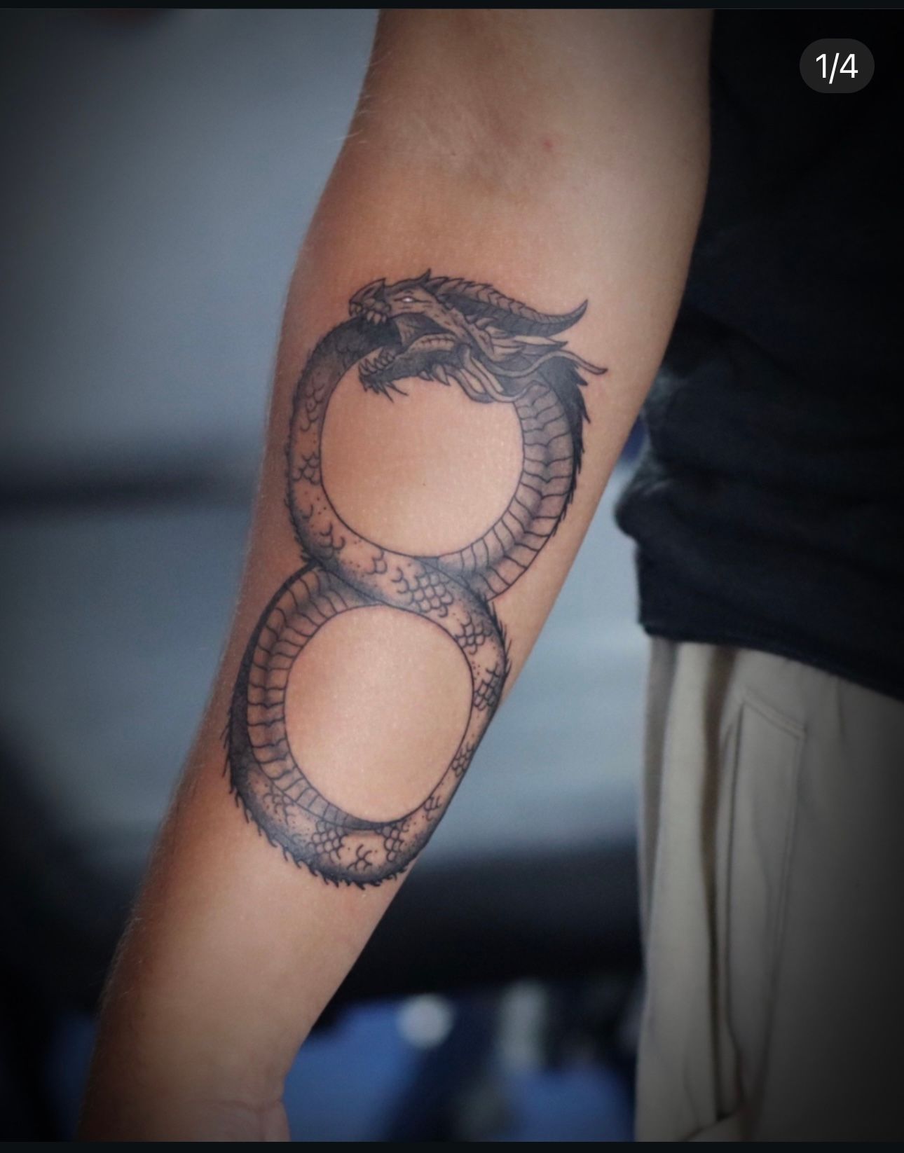 A man has a tattoo of an infinity symbol on his arm