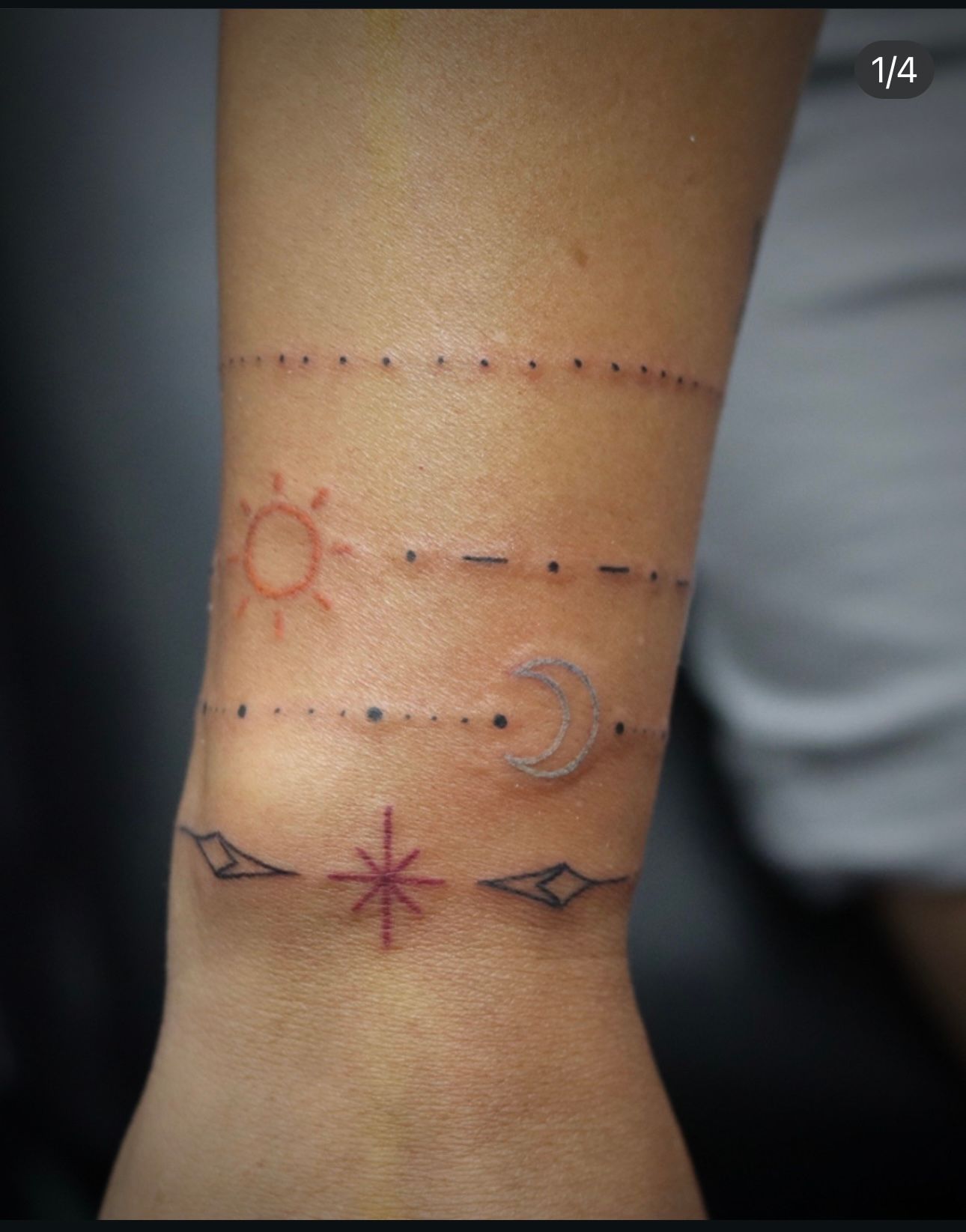 A person has a tattoo on their wrist that looks like a bracelet