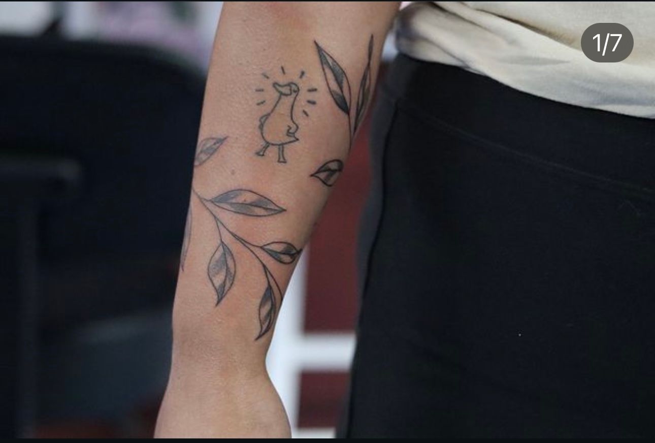 A close up of a person 's arm with a tattoo on it