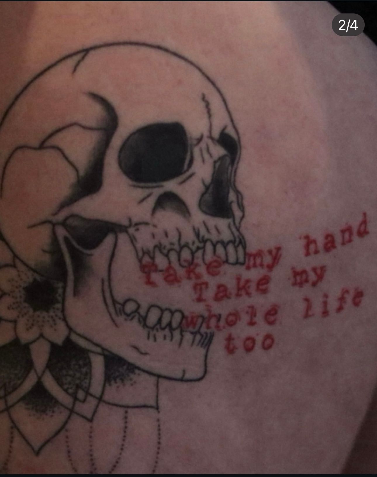 A tattoo of a skull with the words 