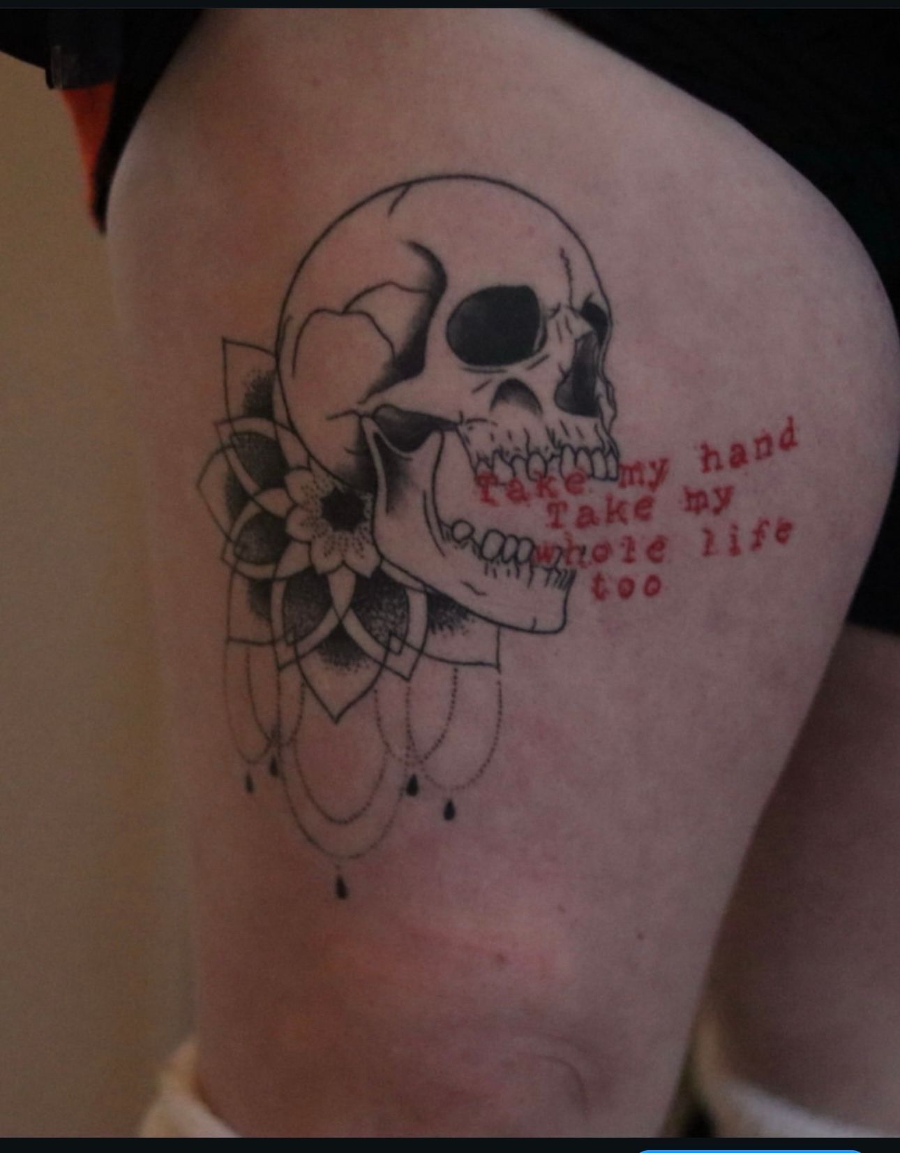 A person has a tattoo of a skull on their leg