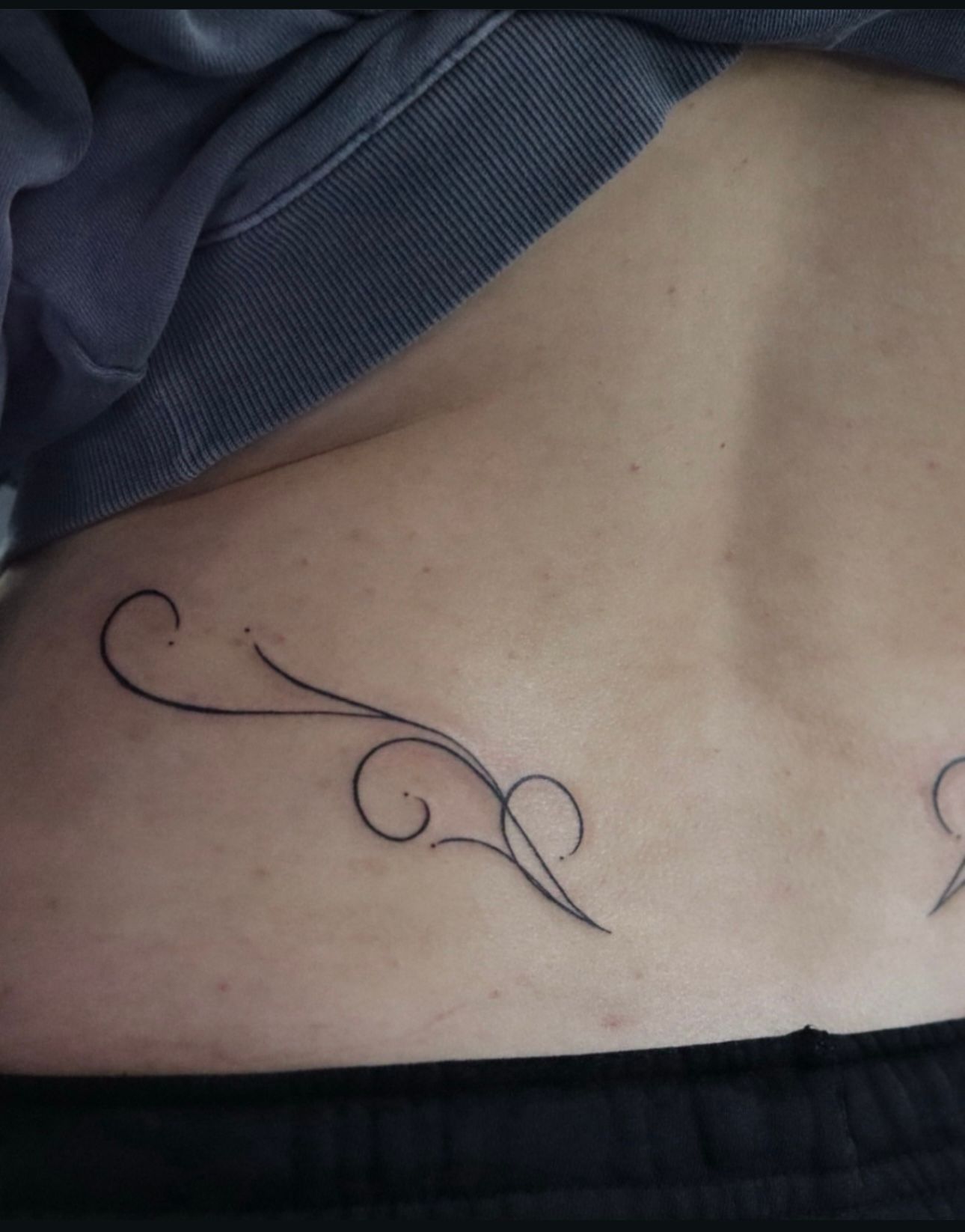 A close up of a tattoo on a person 's back