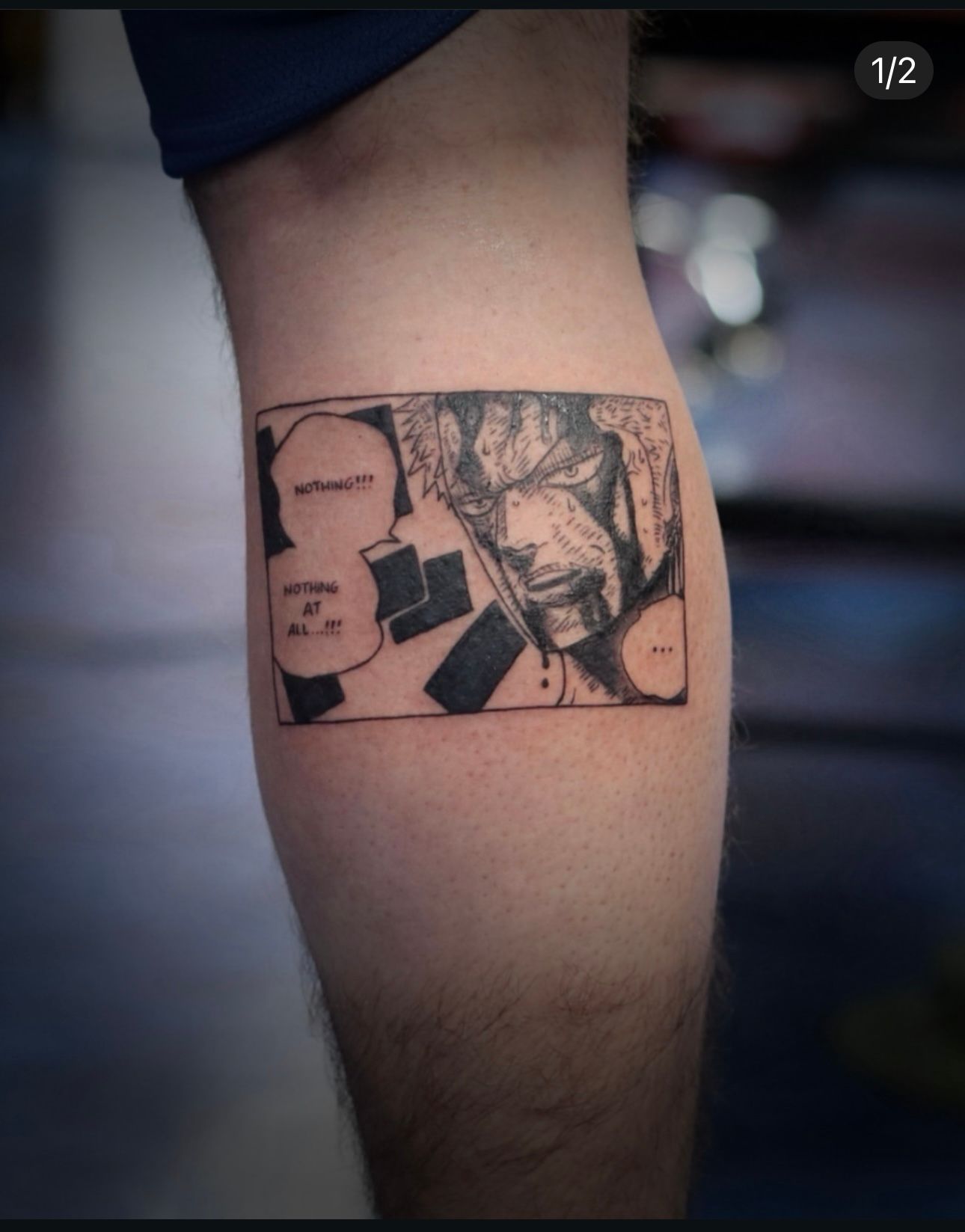 A black and white tattoo on a person 's leg