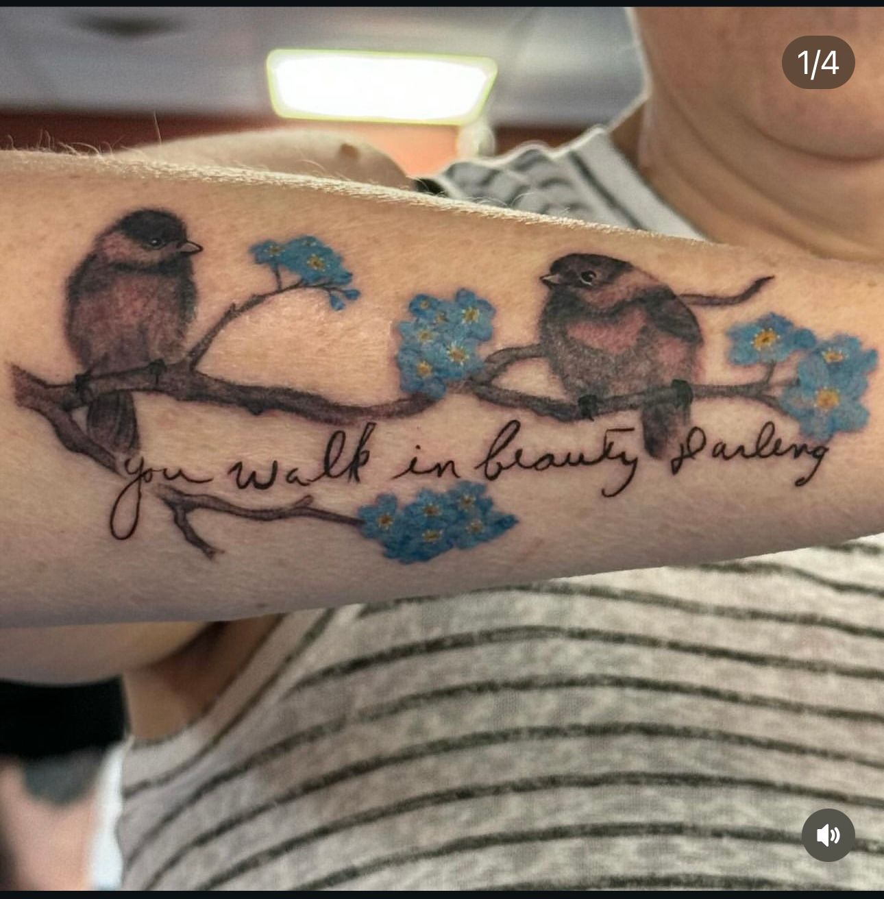 A tattoo on a woman 's arm that says you walk in beauty darling
