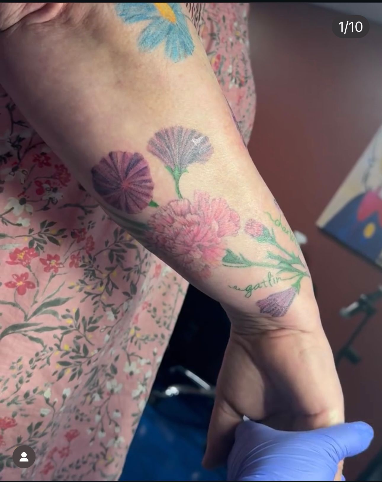 A woman has a tattoo of flowers on her arm