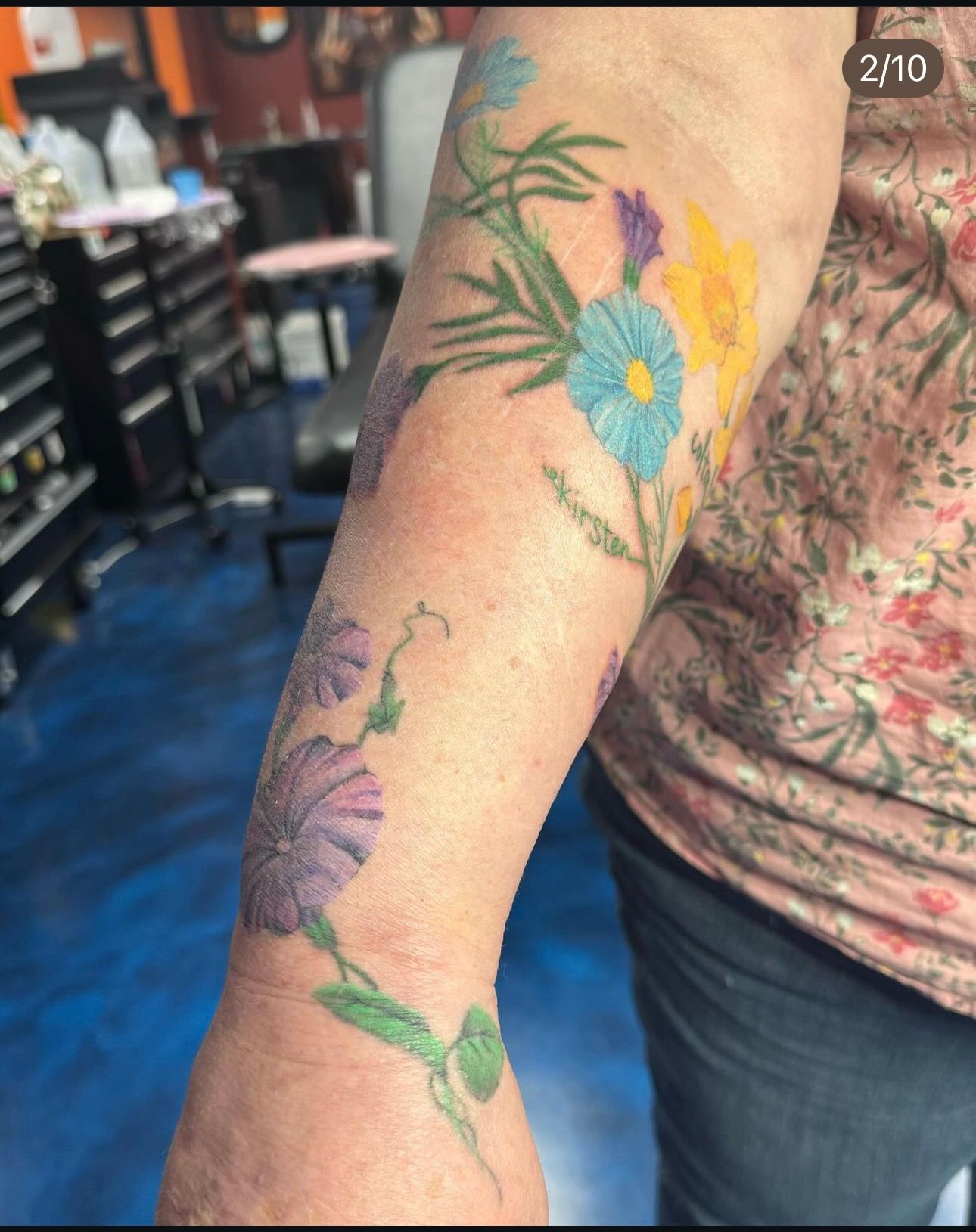 A woman has a tattoo of flowers on her arm