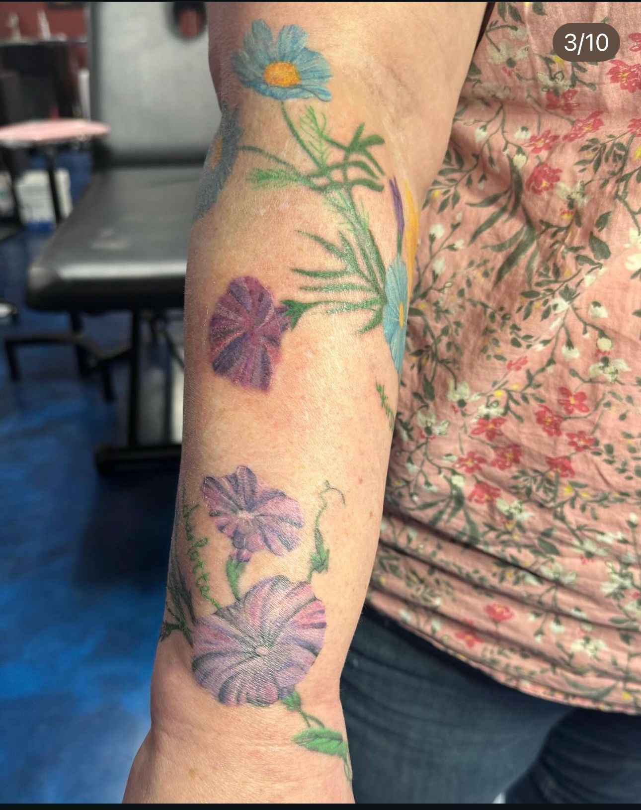 A woman has a tattoo of flowers on her arm.