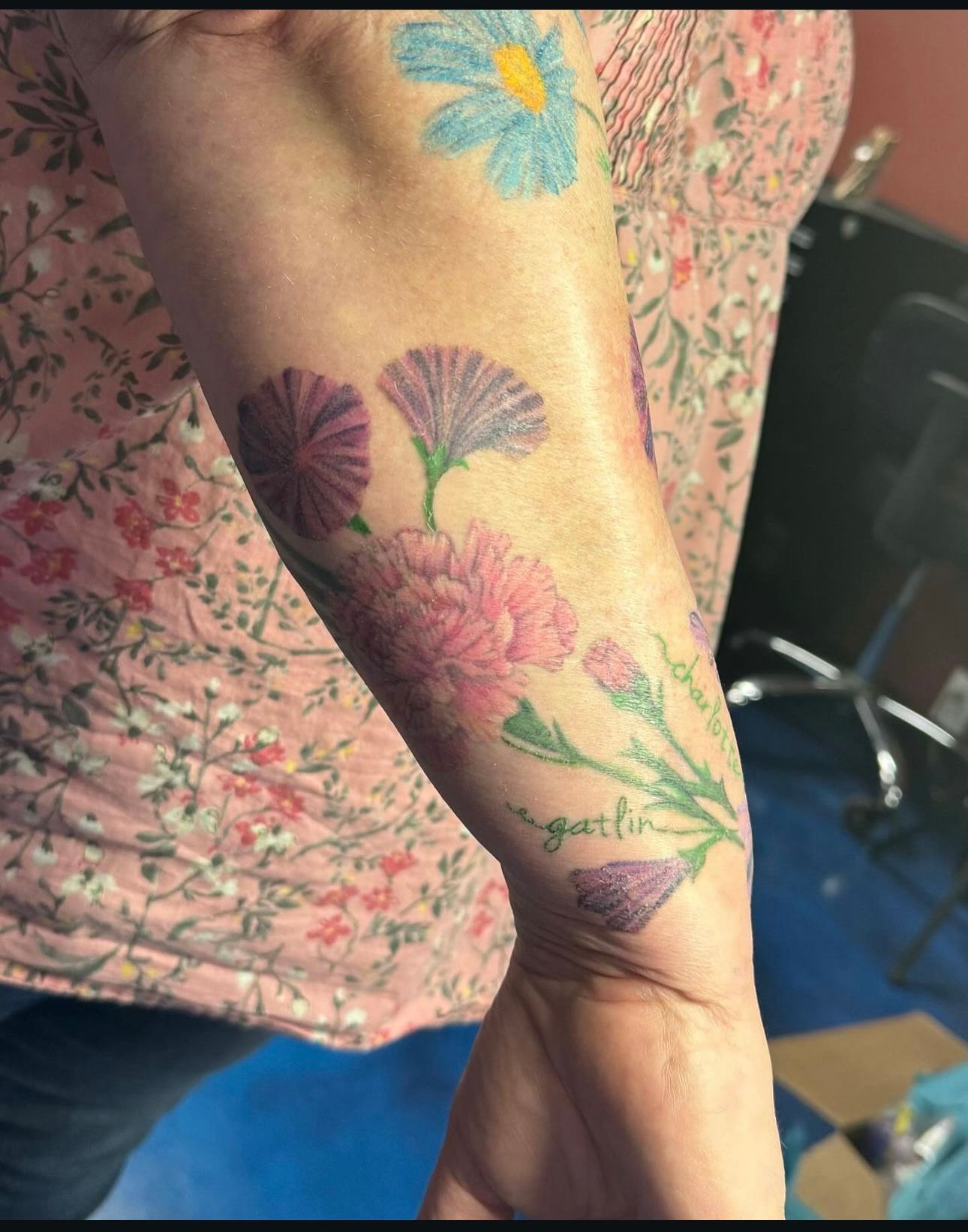 A woman has a tattoo of flowers on her arm