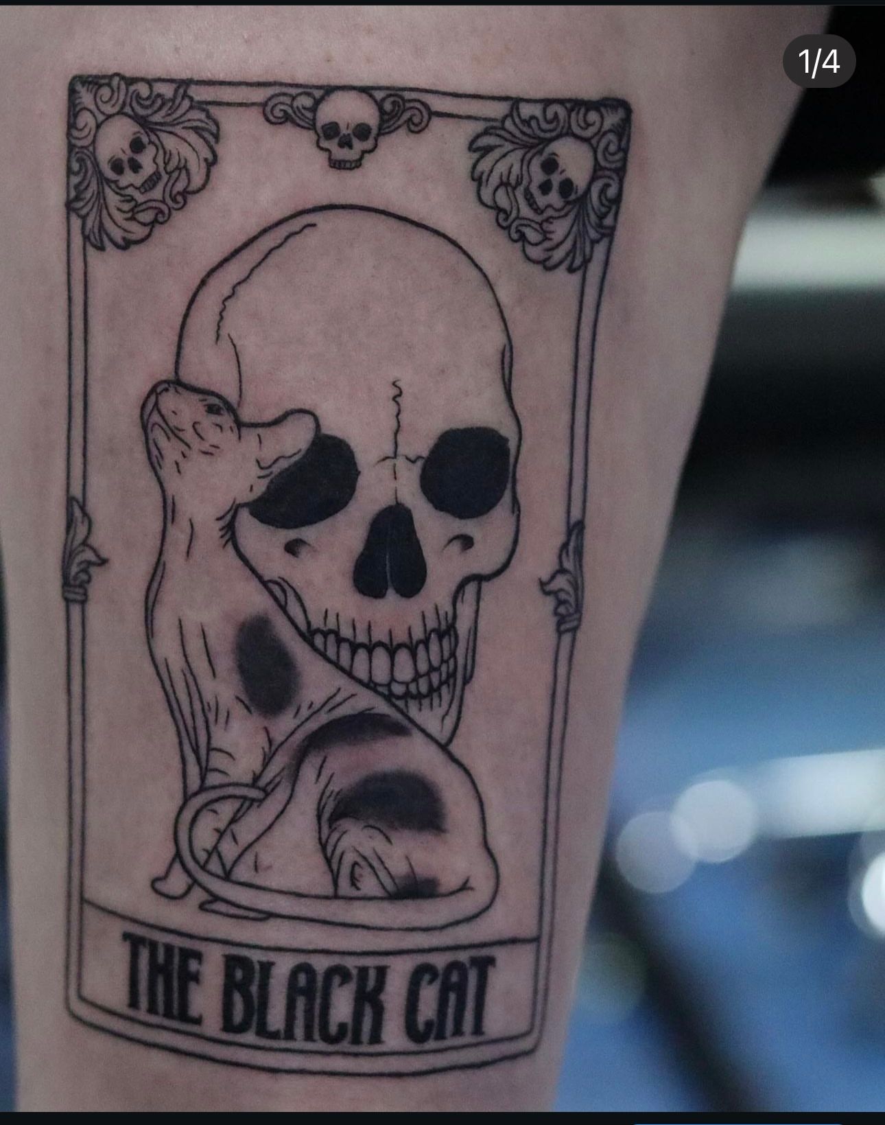 A tattoo of a skull with a mouse and the words the black cat
