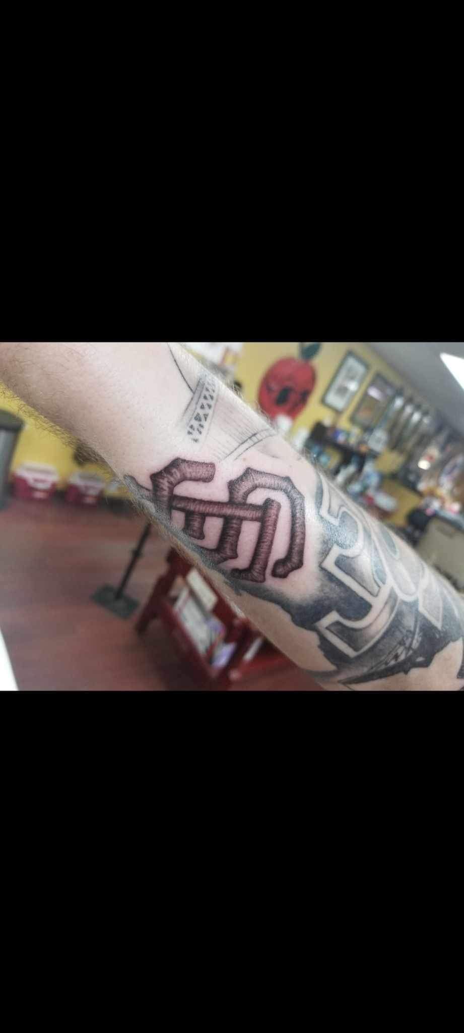 A close up of a person 's arm with a tattoo on it.