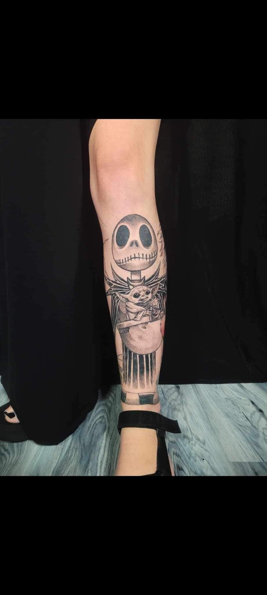 A woman has a tattoo of a skull on her leg.