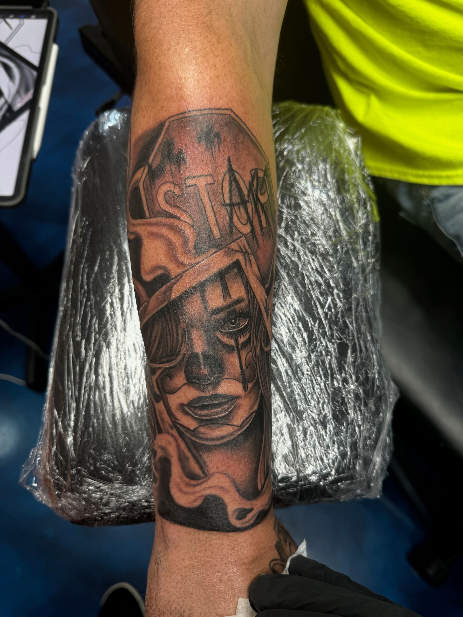 A man has a tattoo on his arm that says star