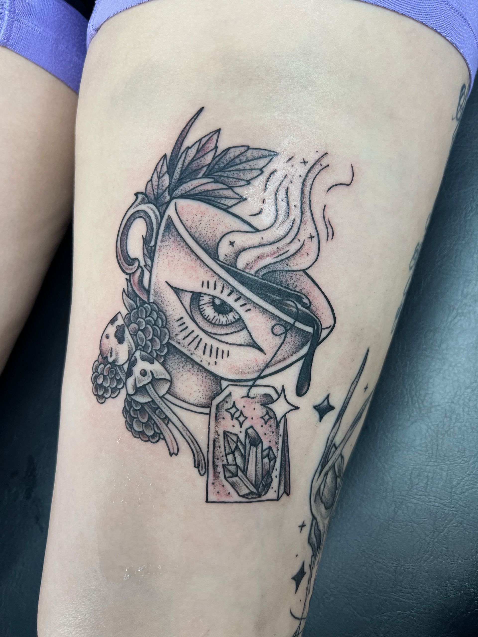 A tattoo of an eye in a cup of tea
