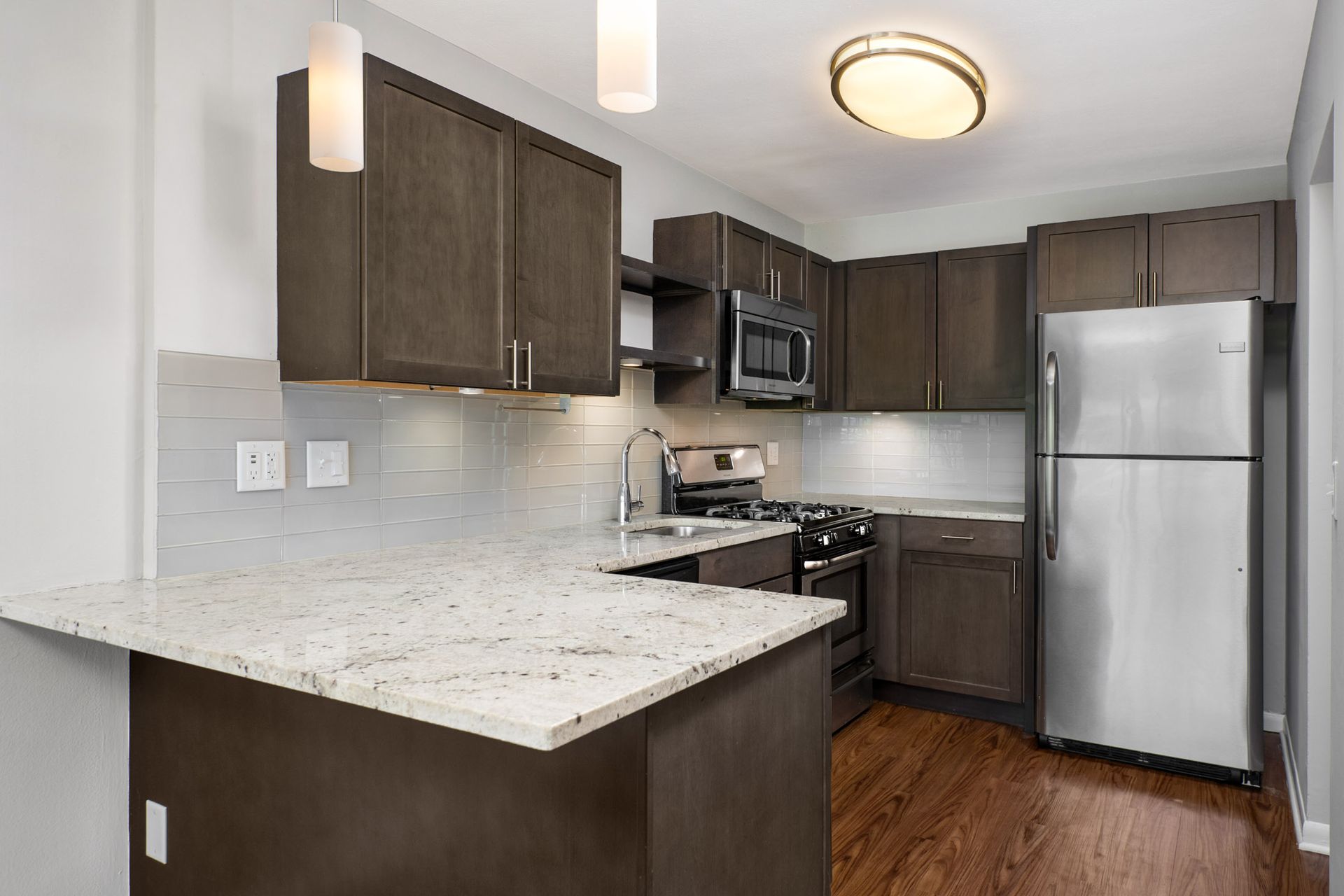 A kitchen with stainless steel appliances and granite counter tops at Reside on North Park.