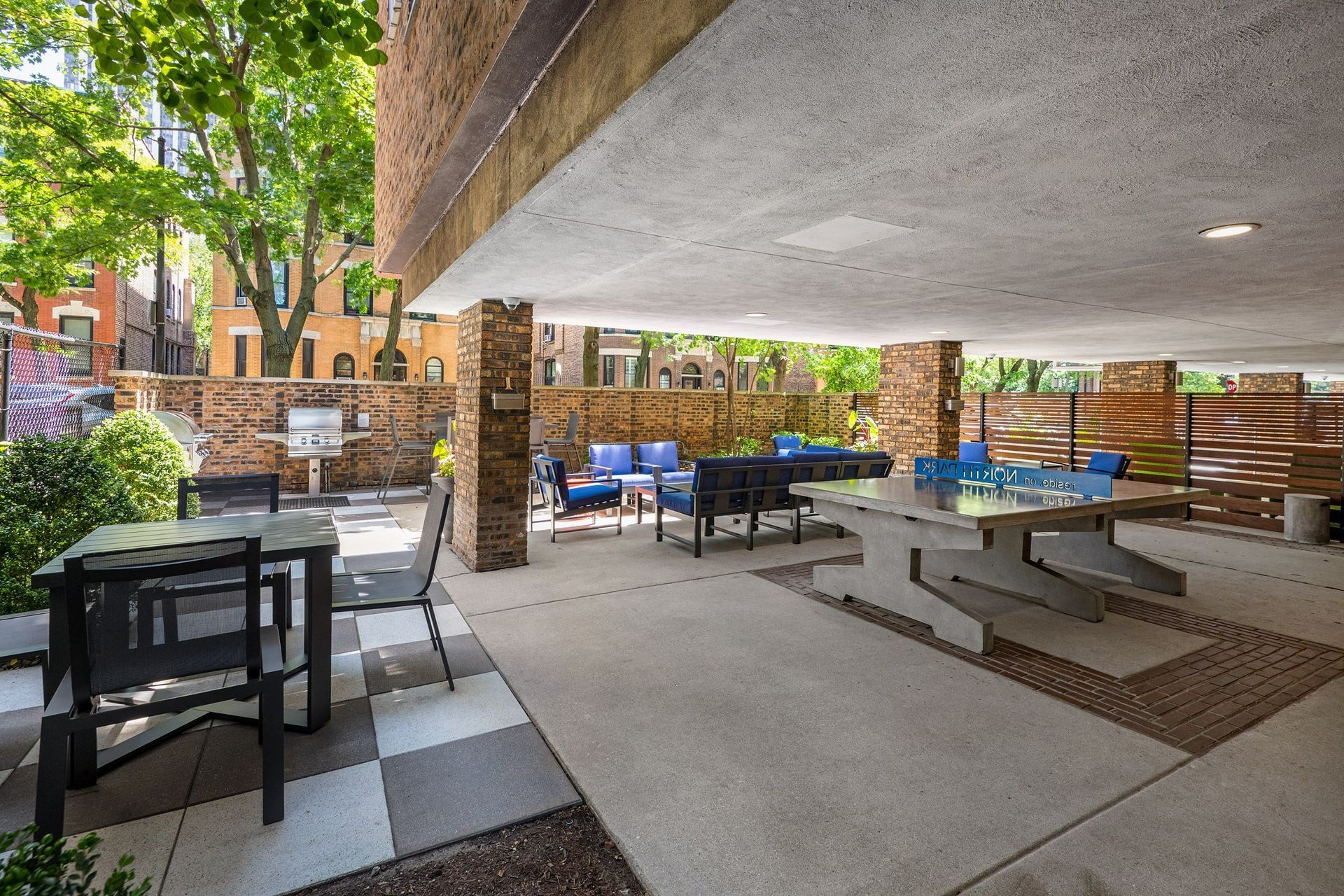 a patio with tables and chairs and a pool