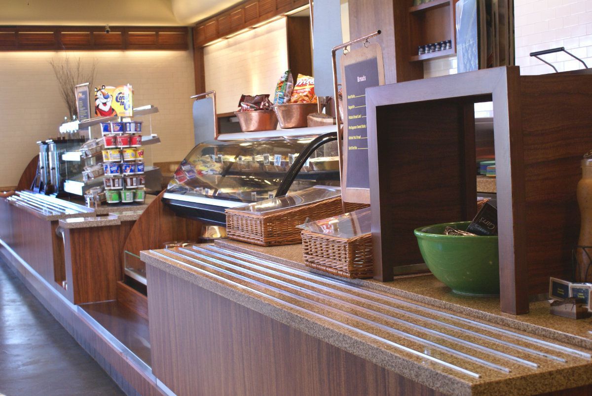 A counter in a restaurant with a sign that says ' yogurt ' on it