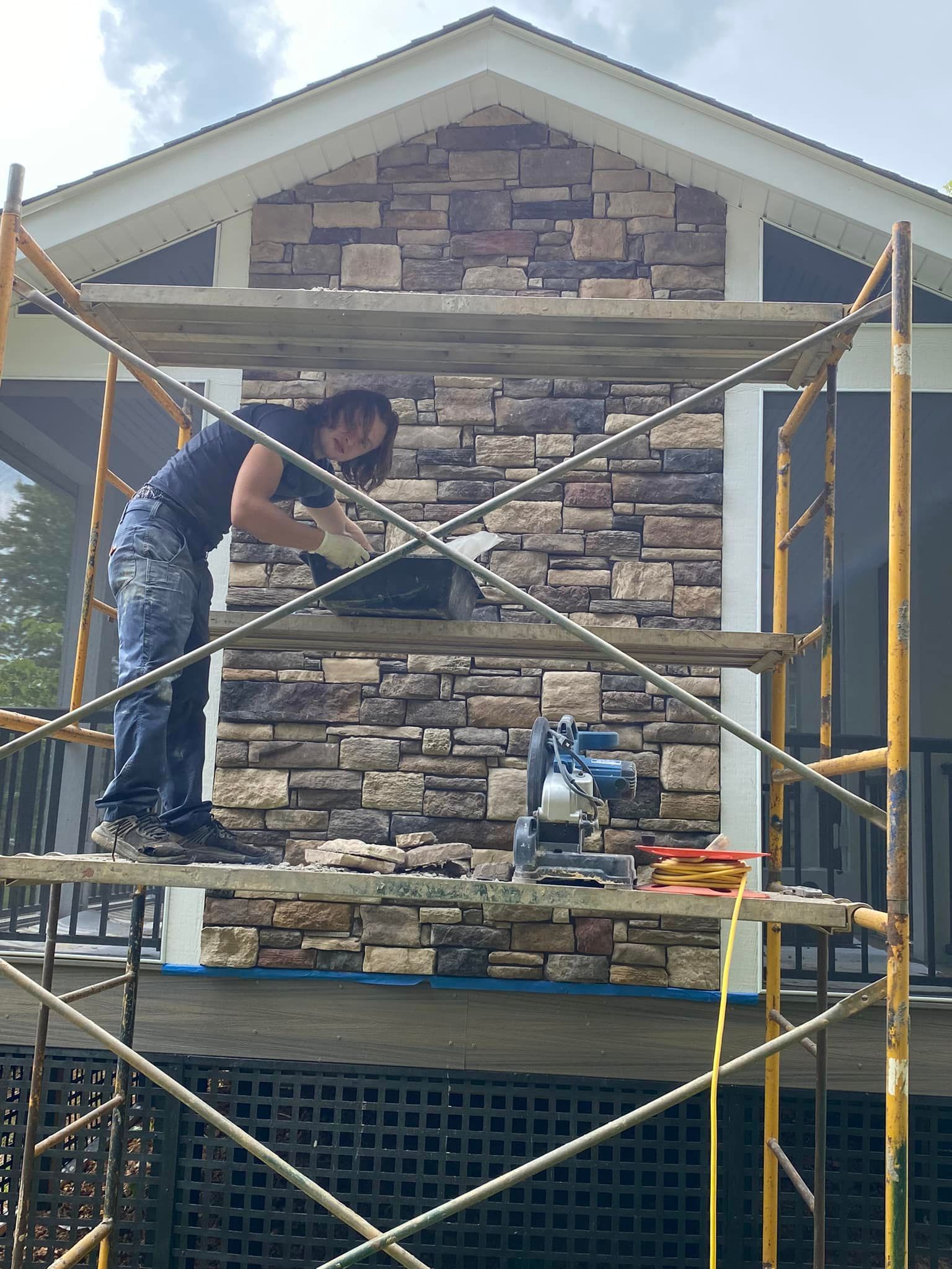 A man working for the stone brick wall